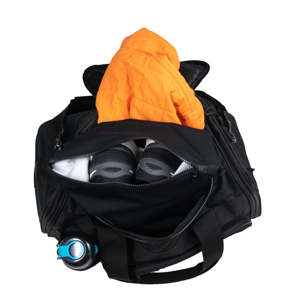 black gym bag with orange jacket Ornadi gym clothes bag separating sneakers on white background